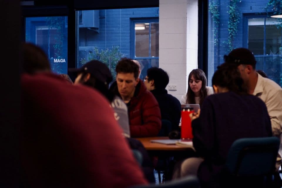 A small group of youth ministers talking around a table.